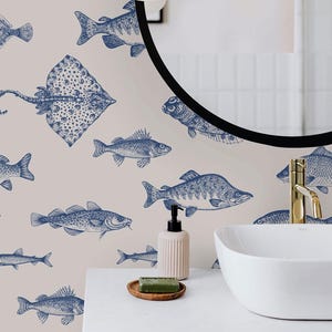 May include: Wallpaper featuring a repeating pattern of dark blue line-art illustrations of various fish and a stingray on a light beige background. The design includes detailed sketches of aquatic life, showcasing different species in a nautical style.