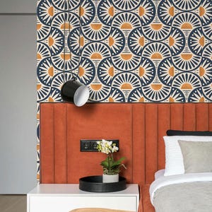 May include: Wallpaper featuring a repeating geometric pattern of dark blue and orange semicircles arranged in a fan-like motif. The design consists of alternating dark blue and orange arcs on a cream background, creating a structured, symmetrical visual.