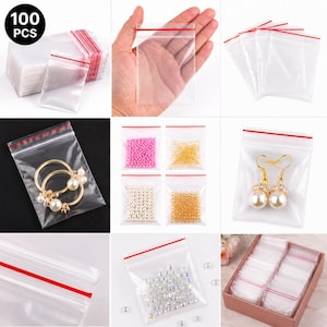 May include: Clear plastic zip-top bags with a red seal, shown with various contents including jewellery and beads. The bags are displayed in stacks and individually, with the text "100 PCS" visible in the corner.