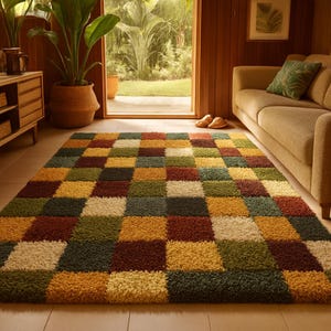 May include: A rectangular rug with a vibrant checkerboard design in yellow, green, brown, and cream. The rug is positioned on a tiled floor, with a sofa and plants visible in the background, creating a warm, inviting atmosphere.