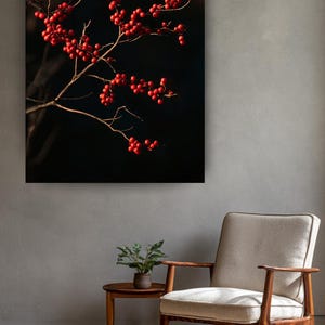 May include: A rectangular wall art print featuring a close-up of thin, bare brown branches laden with clusters of small, vibrant red berries set against a deep black background, displayed in a room with a light-colored chair and side table.