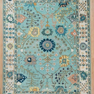 Hand Knotted Wool Oushak Rug: Blue Turkish Design, Ivory Border