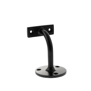 May include: A black metal handrail bracket with a curved support. The bracket features a rectangular mounting plate with two holes and a circular base with four holes. The curved support connects the base and the mounting plate.