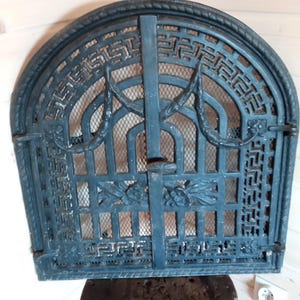 Cast iron art deco openwork fireplace door, made circa 1940s.