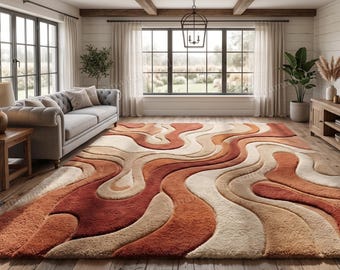 May include: A large, abstract area rug with a wavy design in shades of rust, beige, and cream. The rug is the focal point of a living room with a grey sofa, wooden furniture, and large windows. The rug's dimensions are approximately 244 x 305 cm.