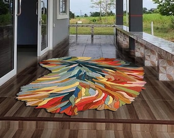 May include: A colorful abstract rug with a unique, organic design. The rug is made of soft, plush fibers and features a variety of colors, including red, orange, yellow, green, blue, and purple.