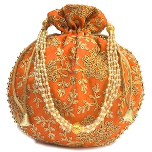May include: Orange drawstring bag with gold embroidery and pearl accents. The bag is decorated with a floral pattern and has a tassel on each side.