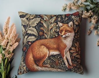 May include: A decorative cushion with a dark blue background featuring a detailed illustration of a red fox standing in a lush green forest. The fox is surrounded by intricate floral patterns and leaves.