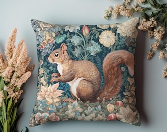 May include: A throw pillow with a dark blue background featuring a detailed illustration of a squirrel surrounded by colourful flowers and leaves.