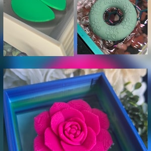 May include: A collage of three aquatic-themed items. A green lily pad floats in a white container. A green floral-patterned ring floats in water. A bright pink rose rests in a blue container.