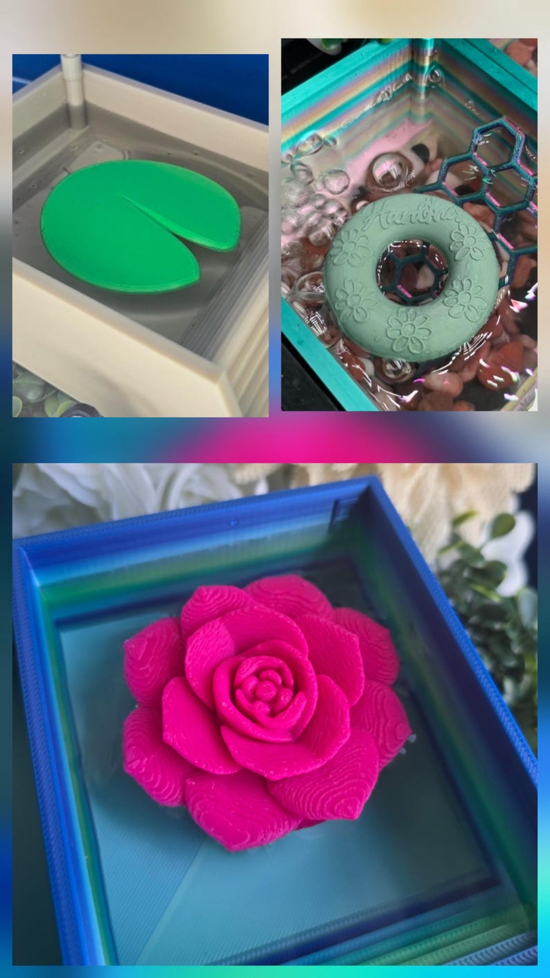 May include: A collection of three square, multi-colored 3D-printed containers filled with water. One container holds a bright green lily pad, another contains a sage green floral ring, and the third features a vibrant hot pink rose sculpture.