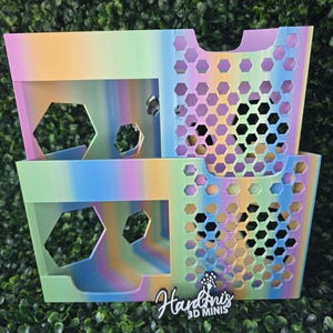 May include: Two stacked, rainbow-colored storage bins with hexagonal cutouts and handles. The bins have a gradient of pastel colors, including pink, yellow, blue, and green. The text "Hardnis 3D MINIS" is visible on the front.