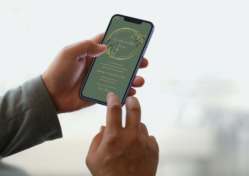 May include: A smartphone displays a green invitation with gold floral accents and text in German. The phone is held by a person, with a finger touching the screen. The invitation is for a Christmas party.