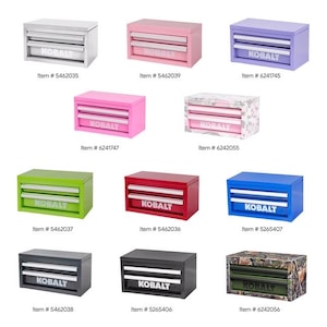 May include: A collection of eleven metal tool chests with two drawers each, featuring the brand name KOBALT printed on the front. The chests are available in various solid colors including white, pink, purple, green, red, blue, gray, and black, plus two camouflage patterns.