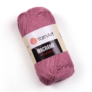 Pink color yarn skein in white background. 100% polyester yarn. YarnArt macrame cord.