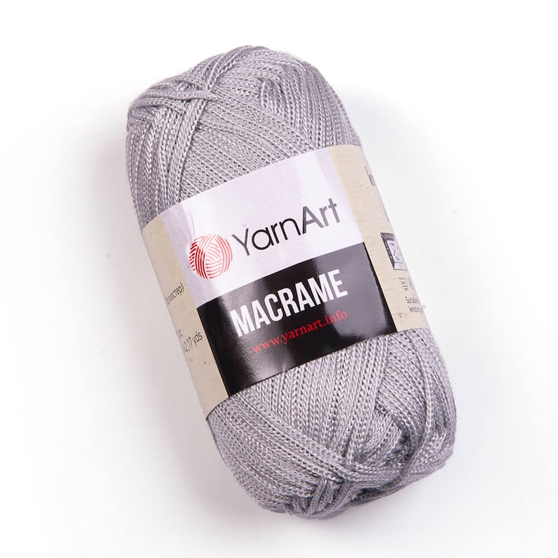 Grey color yarn skein in white background. 100% polyester yarn. YarnArt macrame cord.