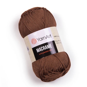 Brown color yarn skein in white background. 100% polyester yarn. YarnArt macrame cord.