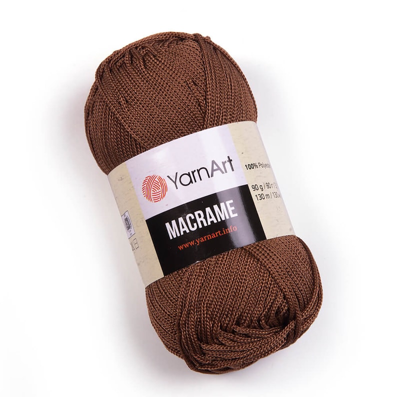 Brown color yarn skein in white background. 100% polyester yarn. YarnArt macrame cord.