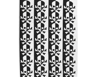 May include: Black and white repeating pattern of skull and crossbones. The skulls are half black and half white, and the crossbones are black. The pattern is repeated vertically in three columns.
