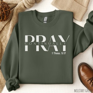 May include: A dark green sweatshirt with the words "Pray Continually" and "1 Thess. 5:17" printed in white.