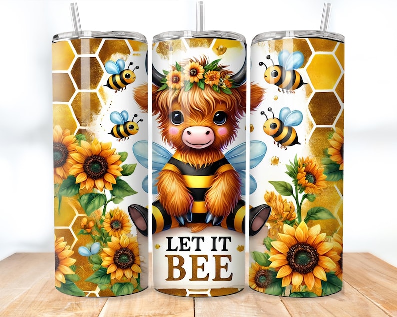 May include: A white tumbler with a cartoon highland cow wearing a bee costume and a sunflower design. The tumbler has the text "Let it Bee" on the front.