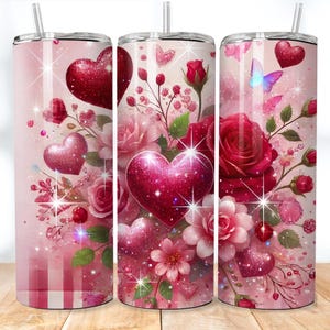 May include: Three stainless steel tumblers with a pink and red glitter design featuring hearts, roses, and butterflies. The tumblers are perfect for Valentine's Day or any romantic occasion.