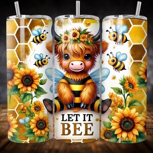 May include: A stainless steel tumbler with a white background featuring a cartoon highland cow dressed as a bee with sunflowers and honeycomb patterns. The text "Let it Bee" is printed on the tumbler.