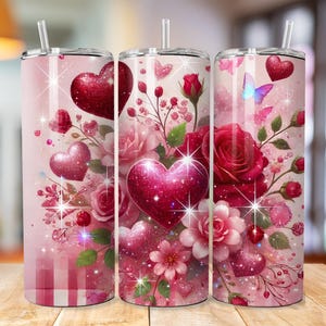 May include: Three stainless steel tumblers with pink, red, and white floral designs. The tumblers feature hearts, butterflies, and glitter accents.