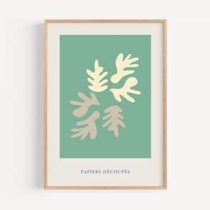 K&ouml;nnte beinhalten: Ein gerahmter Druck mit gr&uuml;nem Hintergrund und einem Design aus f&uuml;nf abstrakten Formen in Beige und Gelb. Der Text "PAPIERS D&Eacute;COUP&Eacute;S" befindet sich am unteren Rand des Drucks.