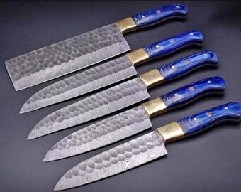 May include: Set of six kitchen knives with blue and gold handles. The blades are made of Damascus steel and have a hammered finish.