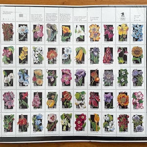 May include: A sheet of 50-cent wildflower stamps featuring colorful floral illustrations. The stamps are arranged in a grid pattern on a white background with a black border. The stamps showcase a variety of flowers in full bloom.