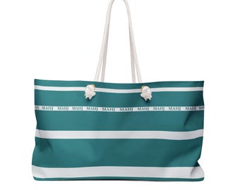 May include: Large teal and white striped tote bag with white rope handles. The bag features the word "MAHJ" printed repeatedly in white along the top. The bag is designed for carrying items.