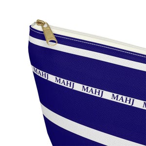 May include: A blue and white striped zippered pouch with the word "MAHJ" repeated across the front.
