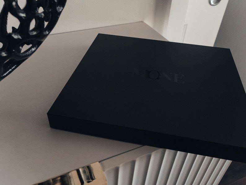 May include: A black box with the word "ONE" embossed on the top.