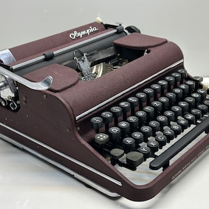 Bordeaux coloured  Olympia SM1 Typewriter - Smooth Operation, Easy Typing, and Sleek Black Keys