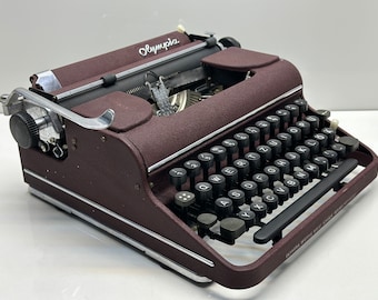 Bordeaux coloured  Olympia SM1 Typewriter - Smooth Operation, Easy Typing, and Sleek Black Keys