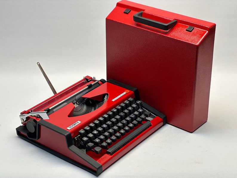 1955 Olympia Traveller Typewriter - Classic Red Design with QWERTZ Layout