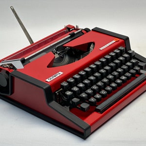 1955 Olympia Traveller Typewriter - Classic Red Design with QWERTZ Layout