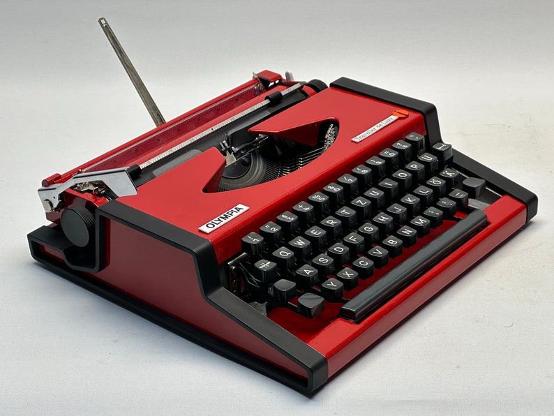 1955 Olympia Traveller Typewriter - Classic Red Design with QWERTZ Layout