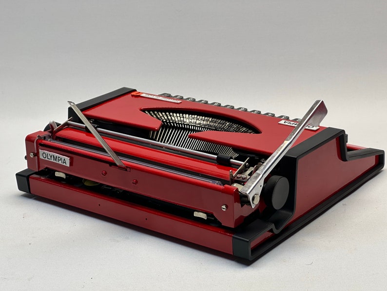 1955 Olympia Traveller Typewriter - Classic Red Design with QWERTZ Layout