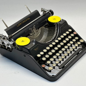 Máquina de escribir Continental negra vintage: teclado QWERTZ de teclas de cristal de la década de 1940