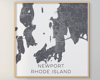 May include: A black and white map print of Newport, Rhode Island, framed in a light wood frame.