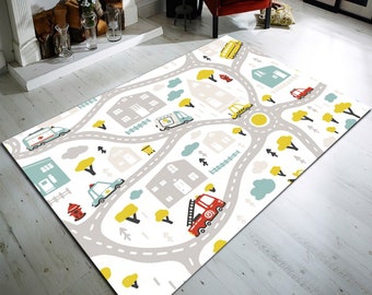 May include: A white play mat with a city road design featuring houses, trees, and various vehicles including a fire truck, ambulance, police car, and a bus. The mat is perfect for imaginative play and learning.