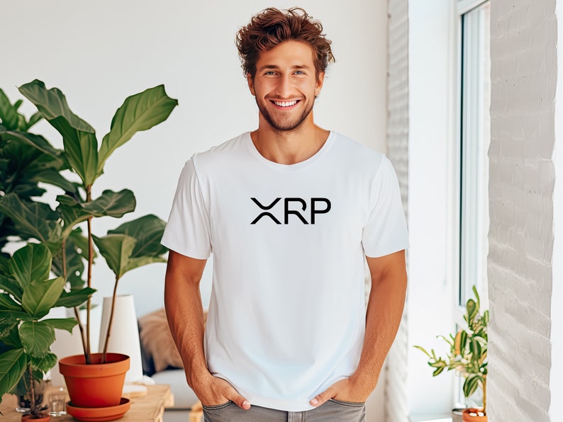 May include: A white t-shirt with a black "XRP" logo printed on the front.