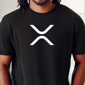 May include: Black t-shirt featuring a white XRP cryptocurrency logo. The logo is a symmetrical design. The shirt is made of a dark fabric and has short sleeves.