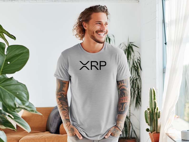 May include: A gray t-shirt with a black "XRP" logo printed on the front.