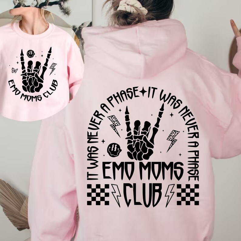 Puede incluir: Sudadera con capucha rosa con un estampado gr&aacute;fico negro que dice "It was never a phase + It was never a phase Emo Moms Club" con un dise&ntilde;o de mano de calavera y rayos.