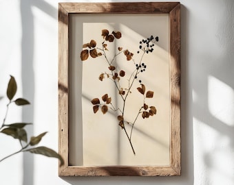 May include: A rectangular wall art piece featuring a pressed botanical specimen with brown leaves and dark berries on a light cream background, encased in a rustic, weathered wooden frame with a visible grain and natural texture throughout.