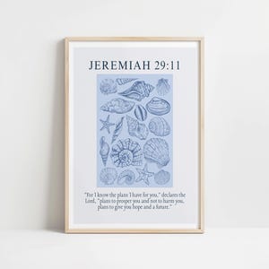 May include: A framed print featuring a collection of blue seashell illustrations on a light blue background. The text "JEREMIAH 29:11" is at the top, with a quote below. The frame is a light wood color.