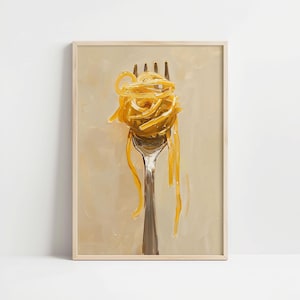May include: A framed art print featuring a close-up of a fork holding a swirl of yellow pasta. The artwork has a painterly style with a neutral background and a wooden frame. The pasta strands are long and flowing.